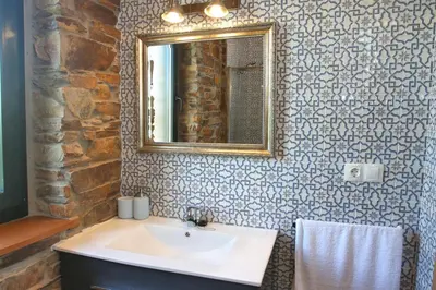 a bathroom with a sink and a mirror at Apartamentos Bouso in Villaframil