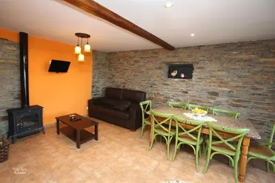 a living room with a table and chairs and a couch at Apartamentos Bouso in Villaframil