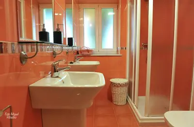 a bathroom with two sinks and a shower at Apartamentos Bouso in Villaframil