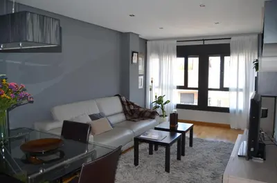a living room with a couch and a table at Orballo Alaricano in Allariz