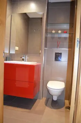 a bathroom with a red sink and a toilet at Orballo Alaricano in Allariz
