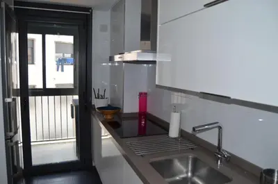 a kitchen counter with a sink and a window at Orballo Alaricano in Allariz