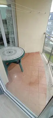 a room with a table on a balcony at Apartamento PLAYAS Y SIRENAS SAN CIPRIÁN in San Ciprián