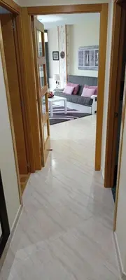 a hallway with a living room with a couch at Apartamento PLAYAS Y SIRENAS SAN CIPRIÁN in San Ciprián