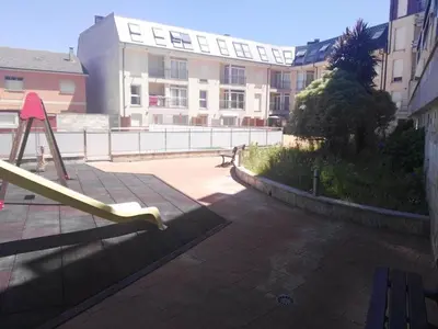 a playground with a slide in front of a building at Apartamento PLAYAS Y SIRENAS SAN CIPRIÁN in San Ciprián