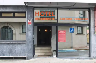 a hotel sign in the window of a building at Hotel Villa de Ares in Ares