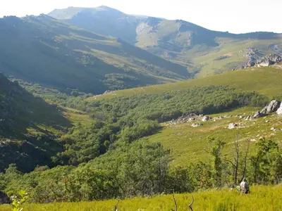 a man standing on a hill looking at a valley at Hostería Camino in Luyego de Somoza