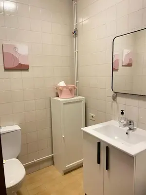 a bathroom with a sink and a toilet and a mirror at Apartmento O Río in Burela de Cabo