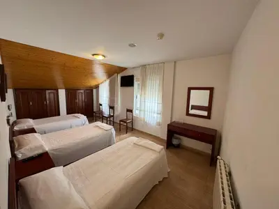 a hospital room with three beds and a table at Hotel Luso Leixoes-Exclusivo para Empresas in Bergondo