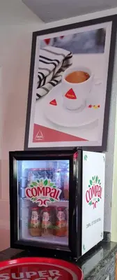 a small refrigerator with a cup of coffee at Hotel Luso Leixoes-Exclusivo para Empresas in Bergondo