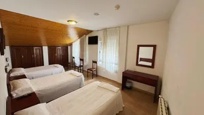 a hotel room with two beds and a mirror at Hotel Luso Leixoes-Exclusivo para Empresas in Bergondo