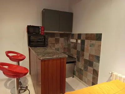 a small kitchen with a counter and a microwave at As casiñas da mina