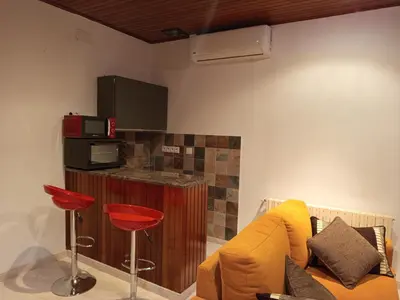 a living room with a couch and a microwave at As casiñas da mina
