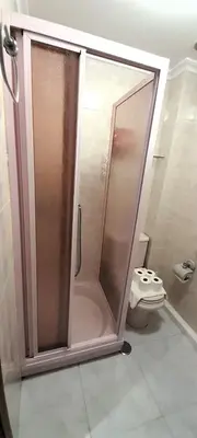 a shower stall in a bathroom with a toilet at EnViveiro Casco Histórico in Viveiro