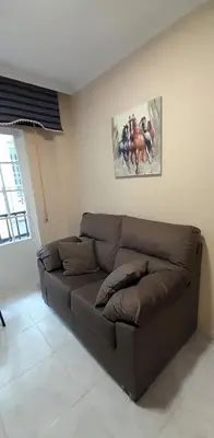 a brown couch sitting in a living room at EnViveiro Casco Histórico in Viveiro