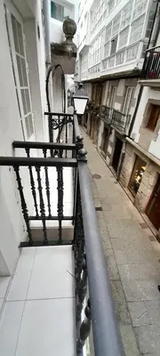 a bench sitting on the side of a building at EnViveiro Casco Histórico in Viveiro