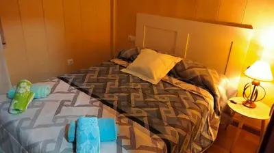 a bed with a toy on it in a bedroom at playa de covas-Viveiro apartment in Viveiro
