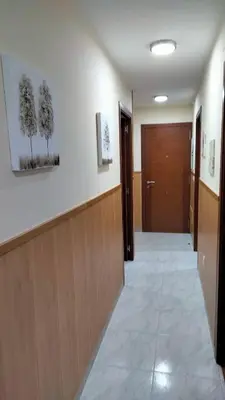 a hallway of a hospital with a door and a hallwayngth at playa de covas-Viveiro apartment in Viveiro