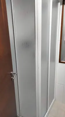 a shower stall with a glass door in a bathroom at playa de covas-Viveiro apartment in Viveiro