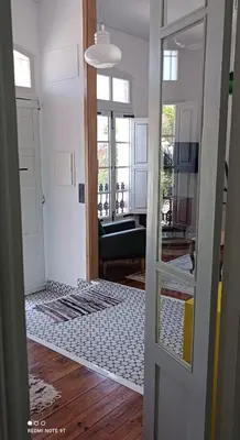 a hallway with a door open to a living room at Casa Matilda - Encanto vintage con patio privado en el corazón de la Ribeira Sacra in Monforte de Lemos