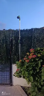 a gate with a bunch of flowers and a street light at Casa Matilda - Encanto vintage con patio privado en el corazón de la Ribeira Sacra in Monforte de Lemos
