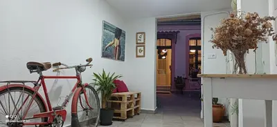 a red bike parked in front of a house at Casa Matilda - Encanto vintage con patio privado en el corazón de la Ribeira Sacra in Monforte de Lemos