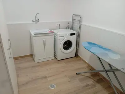 a washing machine in a laundry room with a washer at Roi Roots in Santiago de Compostela