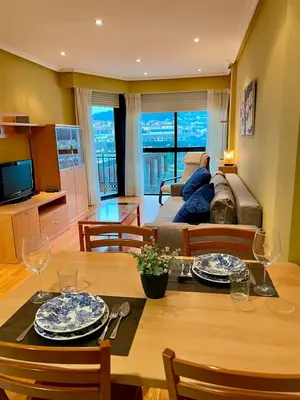 a living room with a table and chairs and a couch at Vistas Miño II in Ourense