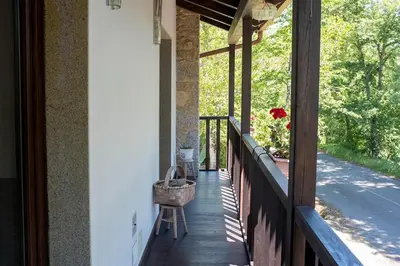 a porch of a house with a basket on it at Casa do Vigairo, en plena Ribeira Sacra