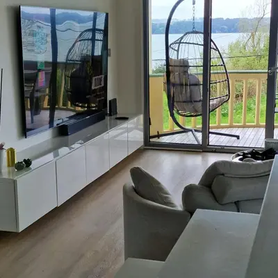 a living room with a chair and a swing at Perbes Dreams in Perbes
