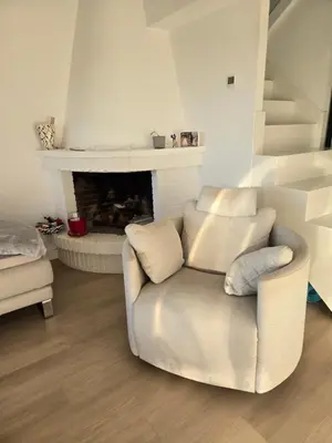 a living room with a chair and a fireplace at Perbes Dreams in Perbes