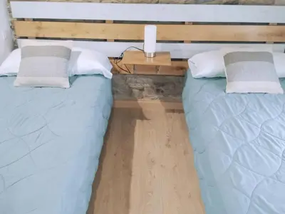 two beds sitting next to each other in a room at Encantadora casa con unas magníficas vistas in Ribadeo