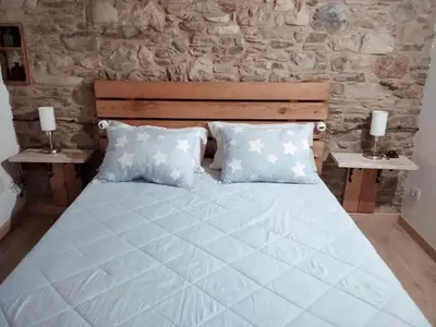 a bedroom with a large bed with two pillows at Encantadora casa con unas magníficas vistas in Ribadeo
