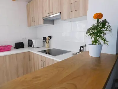 a kitchen with a wooden counter top and a sink at Encantadora casa con unas magníficas vistas in Ribadeo