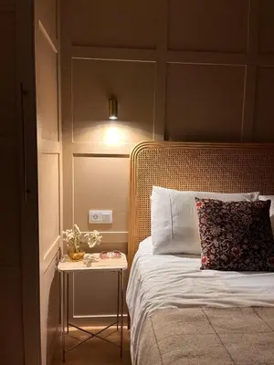 a bedroom with a bed with a side table with a lamp at Casa Paz Lugo in Lugo