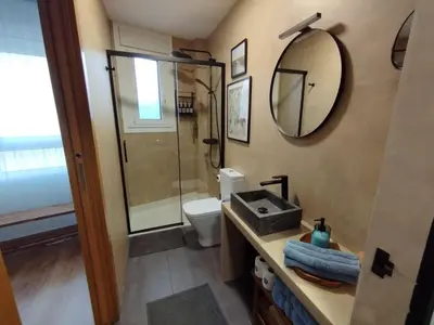 a bathroom with a shower and a toilet and a mirror at Casa Paz Lugo in Lugo