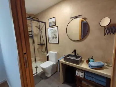 a bathroom with a toilet and a sink and a mirror at Casa Paz Lugo in Lugo