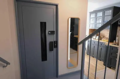 a hallway with a door and a staircase with a mirror at Casa Paz Lugo in Lugo