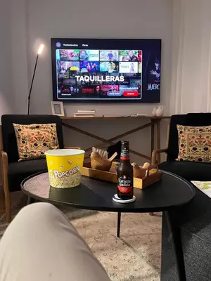 a table with a bottle of beer and a television at Casa Paz Lugo in Lugo