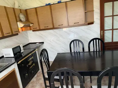 a kitchen with a table with chairs and a microwave at A Marosa playa in Burela de Cabo