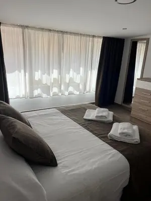 a bedroom with a large bed with two towels on it at Casa da Morena in Foz
