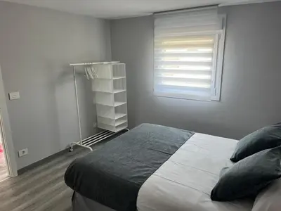 a bedroom with a large bed and a window at Casa da Morena in Foz