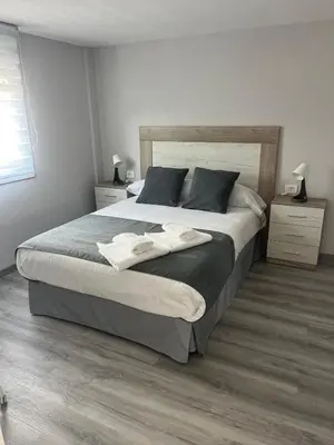 a bedroom with a large bed with two towels on it at Casa da Morena in Foz