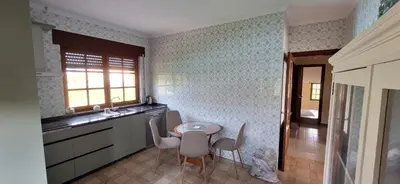 a kitchen with a table and chairs in a room at Casa Diego, primera línea de playa junto a las Catedrales in Barreiros