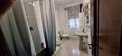 a small bathroom with a toilet and a sink at Casa Diego, primera línea de playa junto a las Catedrales in Barreiros