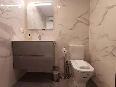 a white bathroom with a toilet and a sink at SF - Luminoso, amplio y recién reformado en el casco histórico in Ourense