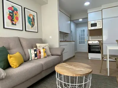 a living room with a couch and a table at Apartamento Pardiñas in Santiago de Compostela