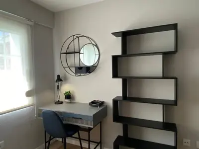 a room with a desk and a shelf at Apartamento Pardiñas in Santiago de Compostela