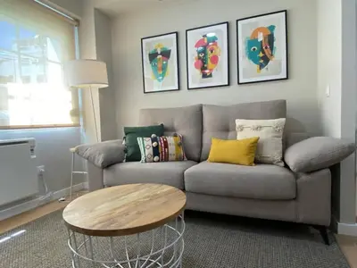 a living room with a couch and a table at Apartamento Pardiñas in Santiago de Compostela