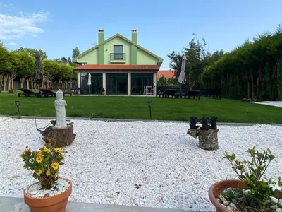a garden with a house and some plants and flowers at Loft anexo en chalet, con piscina de uso privado in San Juan